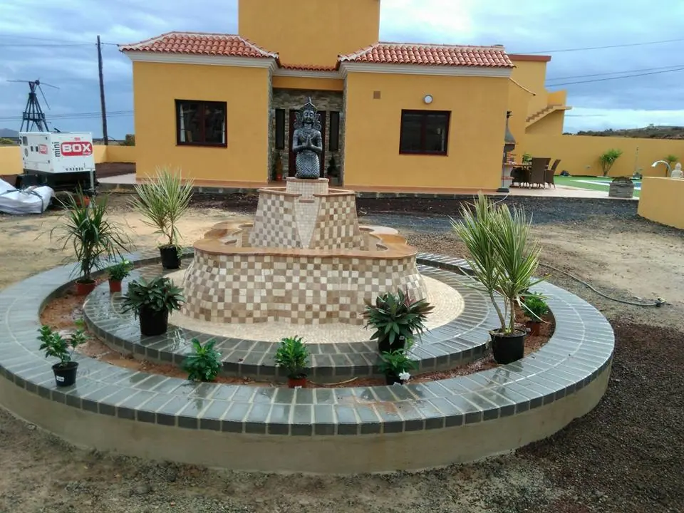 Fuente ornamental circular con jardinera y azulejo decorativo
